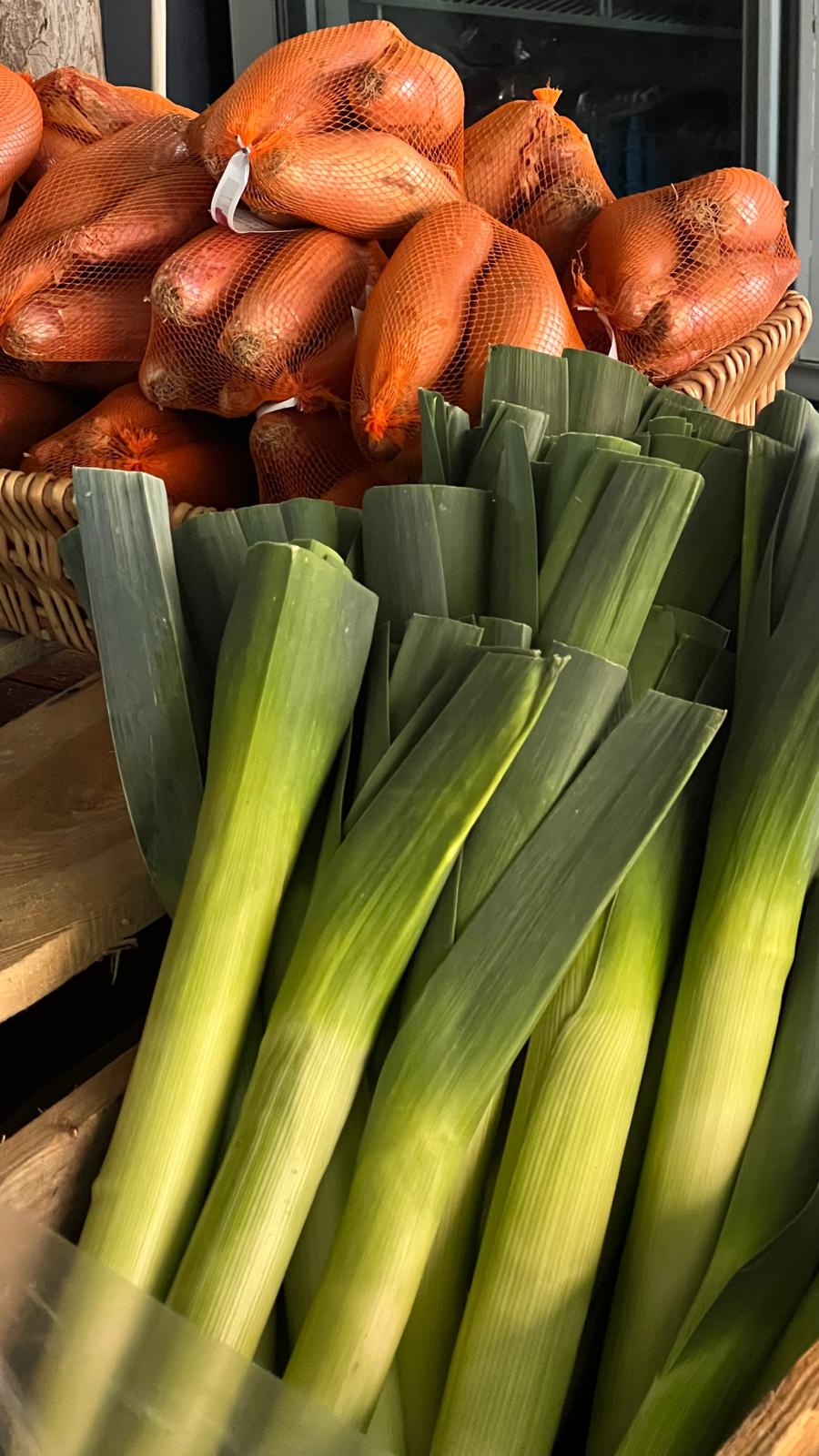 Leeks and onions on display in the farm shop