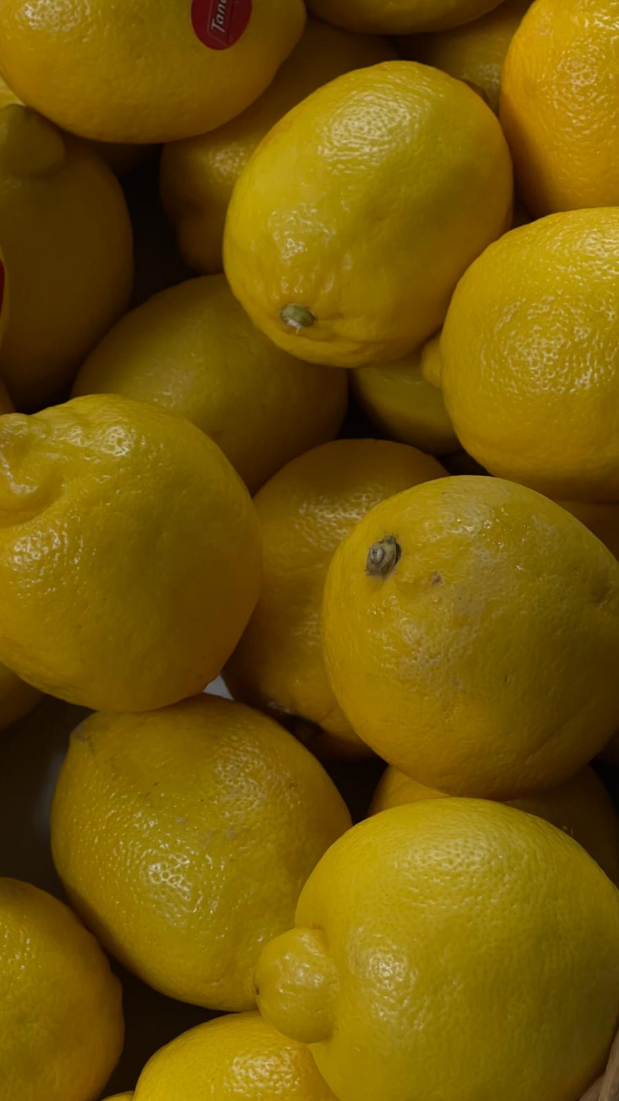 A crate of bright yellow lemons