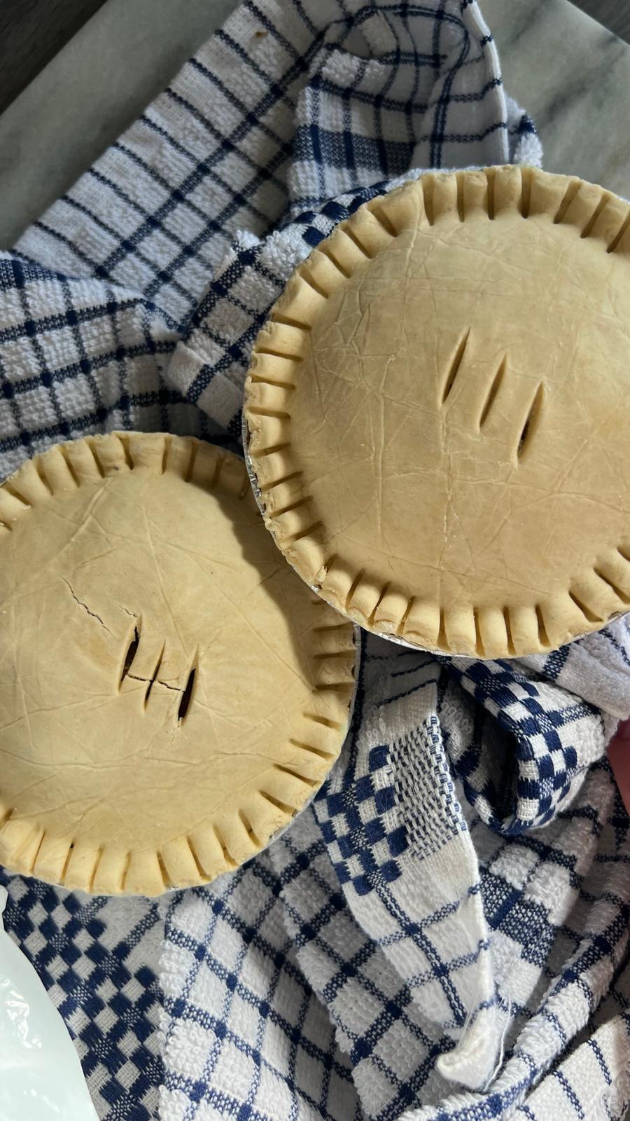 Handmade pies on a tea towel before baking