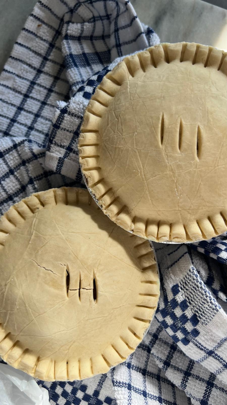 Unbaked pies on a tea towel