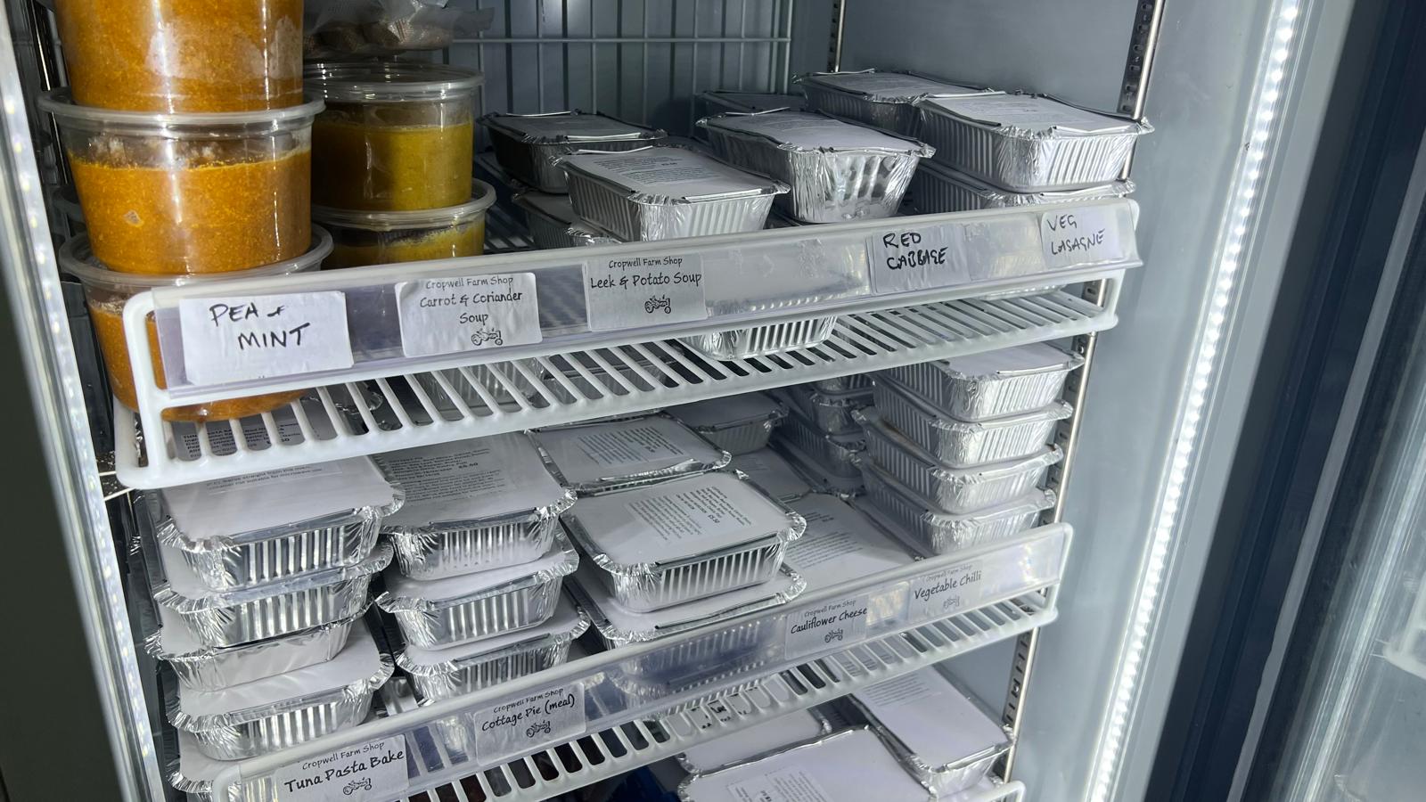 The fridge packed with home-made ready meals in labelled foil trays
