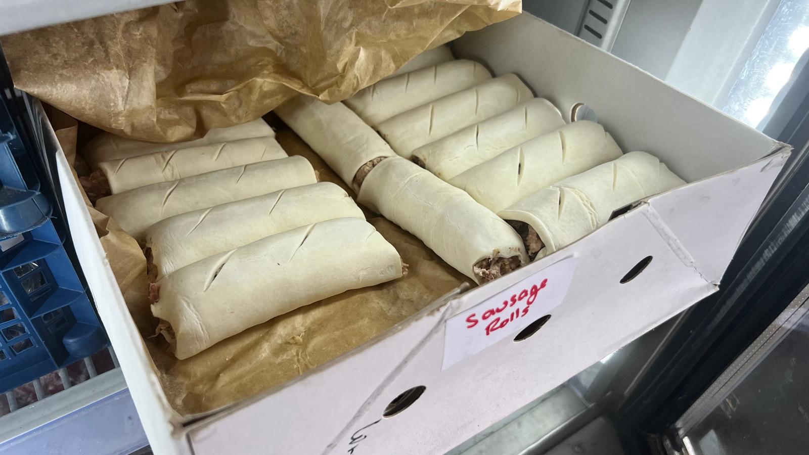 A box of handmade sausage rolls ready for the oven